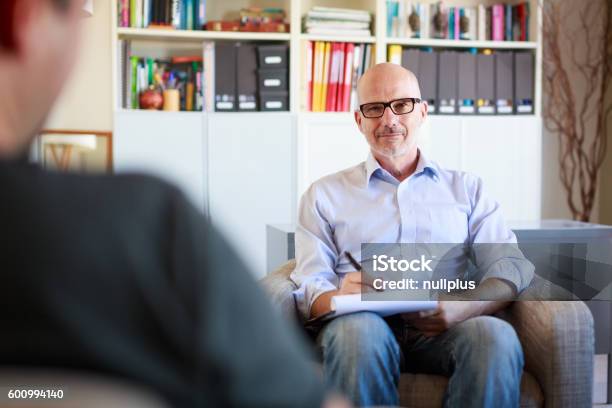 Therapy Session Adult Man Talking To His Psychotherapist Stock Photo - Download Image Now