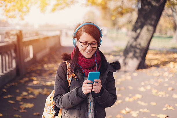 Student girl texting in the park