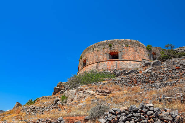 Ruins of main tower of medieval fortress Spinalonga on island Kalydon, Greece.