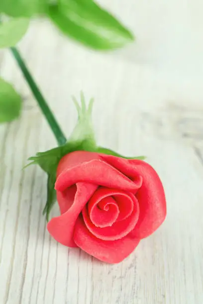 marzipan rose on wooden surface