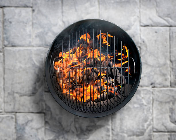 istock Charcoal BBQ on a Concrete Bick Patio 600997420