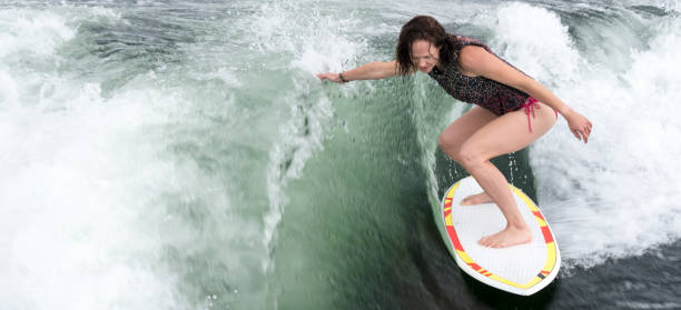istock Young woman wakeboarding, wakesurfing 600998398