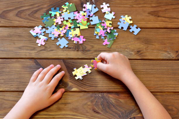 istock Child holding puzzles in hands 600999346