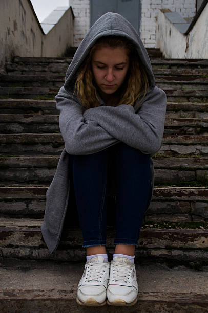 istock Sadness girl sitting on stairs 601000224