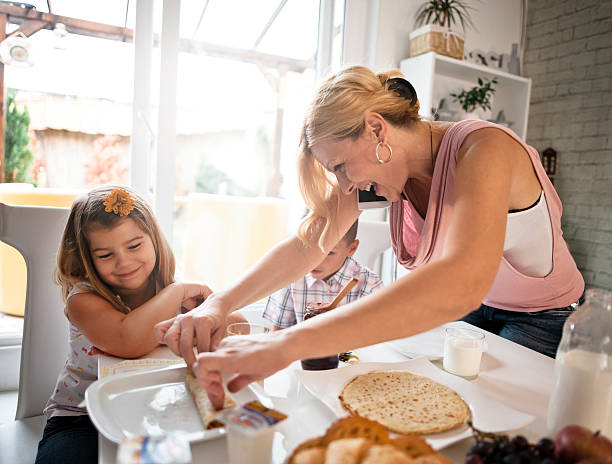 istock Busy Mother Organizing Children At Breakfast In Kitchen 601000922