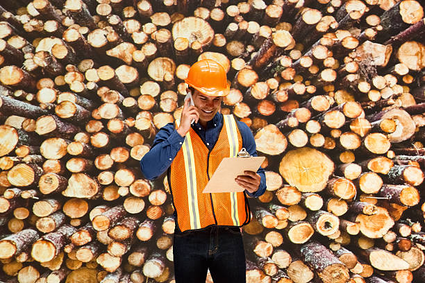 Smiling worker on phone at the lumber industryhttp://www.twodozendesign.info/i/1.png