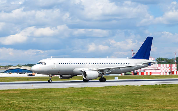 istock Big white passenger jet plane on runway at airport 601002422
