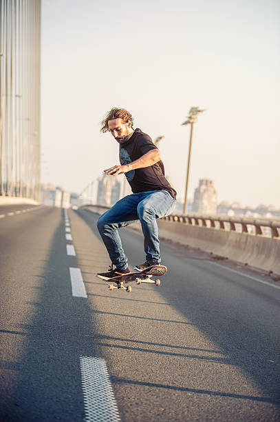 istock Skateboarder doing jumps on the city road bridge 601004082
