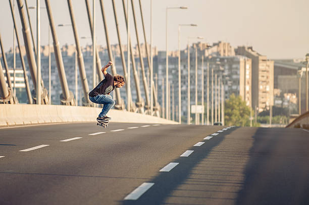 istock Skateboarder doing jumps on the city road bridge 601004126