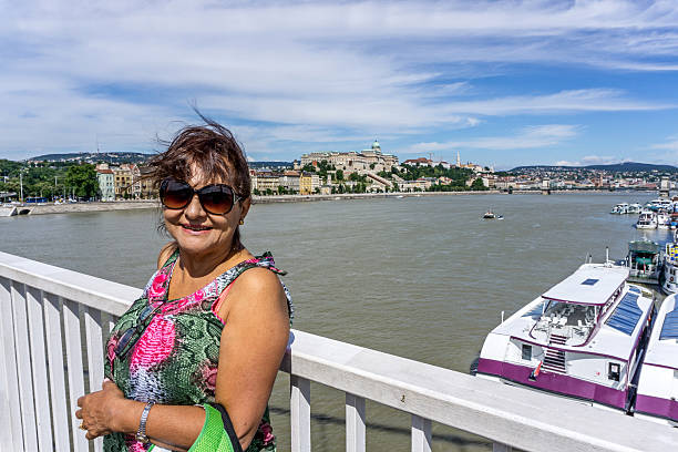 Mature hispanic woman smiling on balcony