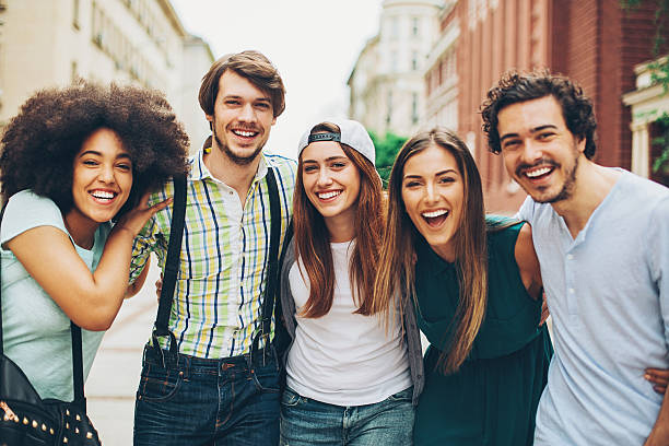 istock Group of smiling young people 601008314