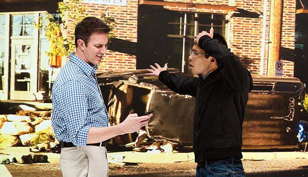 istock Men quarreling in front of car accident 601008732