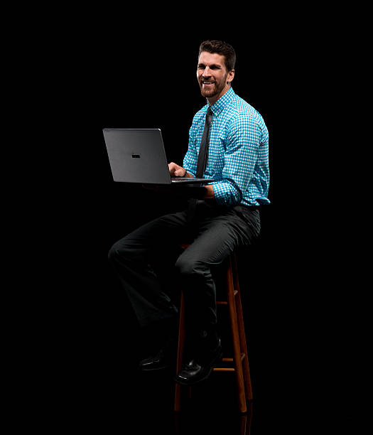 istock Smiling businessman working on laptop 601009298