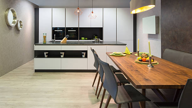 istock flat white kitchen with island unit and wooden dinner table 601011002