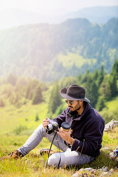 istock Young hiker taking photos on mountain 601011398