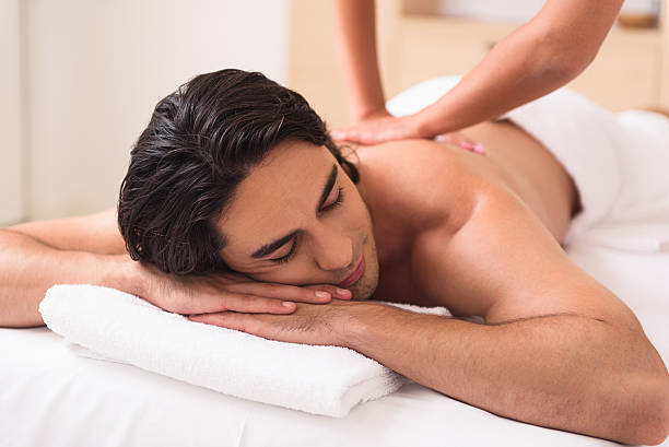 istock Serene guy enjoying treatment at spa 601012424