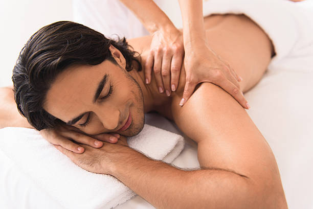 istock Joyful guy relaxing at massaging center 601012674
