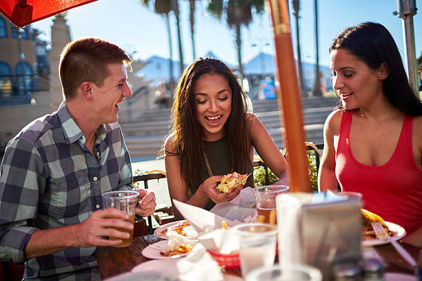 istock friends having fun at outdoor restaurant eating and drinking 601013178