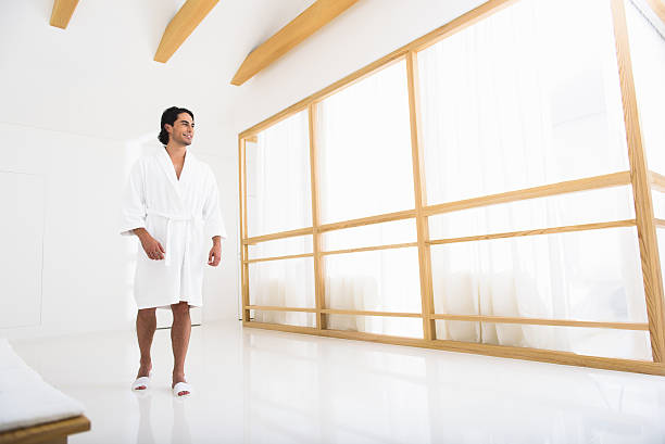 istock Joyful guy in bathrobe at beauty salon 601013684