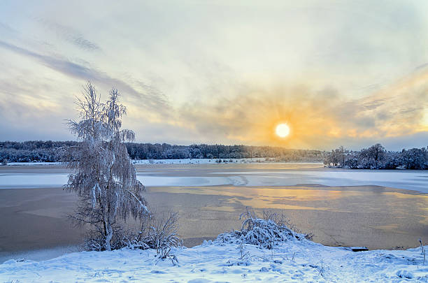 istock Winter landscape with lake and trees covered with frost 601014376