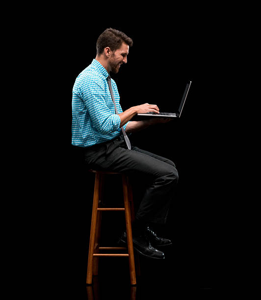istock Smiling businessman working on laptop 601019212
