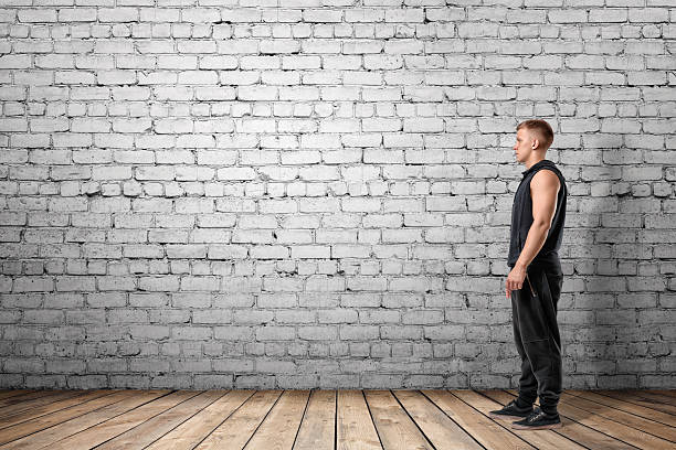 istock Front view of muscled young man standing 601019784
