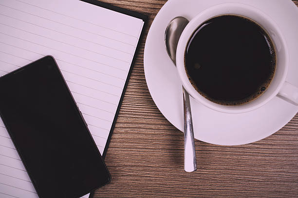 istock Notebook and coffee cup on a wooden surface Vintage Retro 601022244