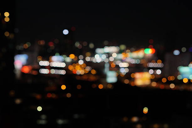 bird eye view  blur photo with bokeh light of high building, high way road, bill board and car in the dark night time