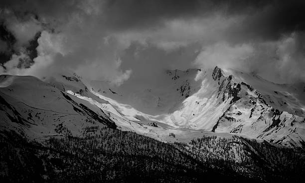istock snowy mountain top a sunny and covered with clouds 601024554