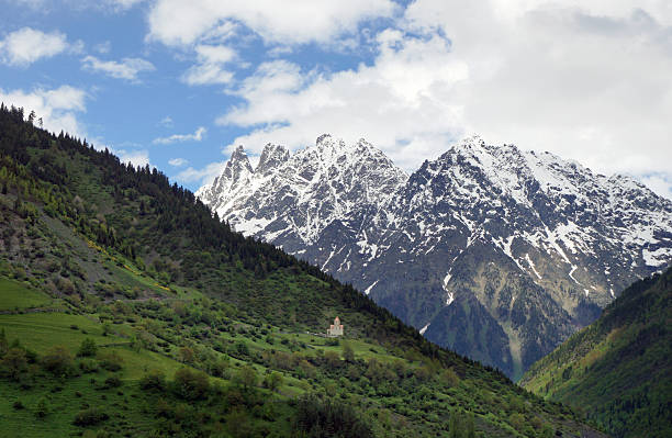 landscape with orthodox church on a hillside mountains