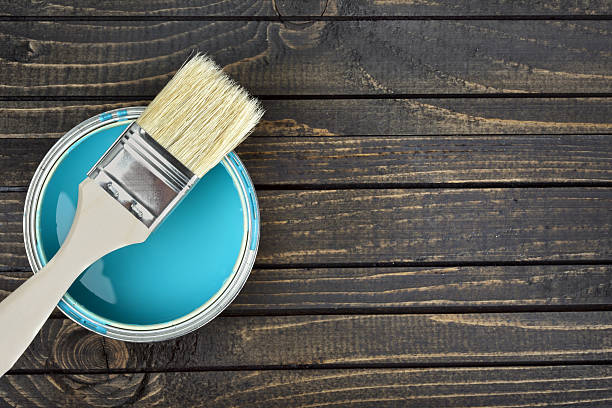 paint bucket and brush on table - paint home improvement paint can decorating imagens e fotografias de stock