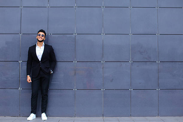 istock Arabic guy in business center stands smiling walking slow 601031748