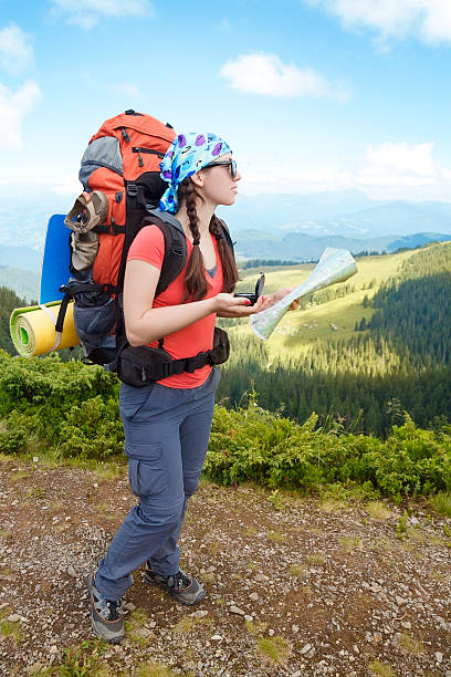 istock Woman hiker in mountains determines the direction 601032566