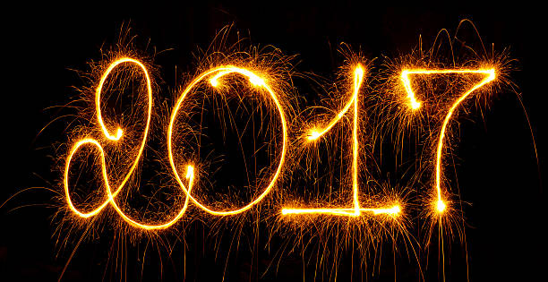 istock Happy New Year - 2017 with sparklers on black 601033674