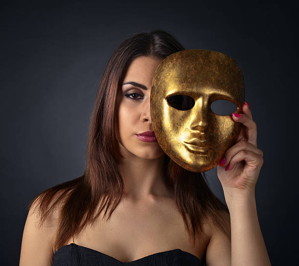 istock Beautiful woman with gold carnival mask 601034534