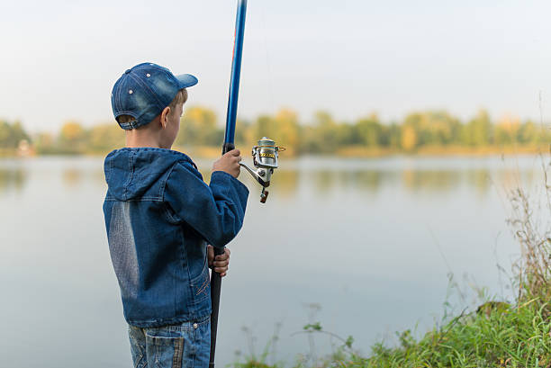 istock child on a summer fishing on the shore 601036364