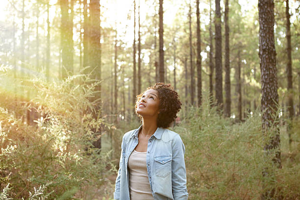 istock Young girl looking up into the trees 601038418