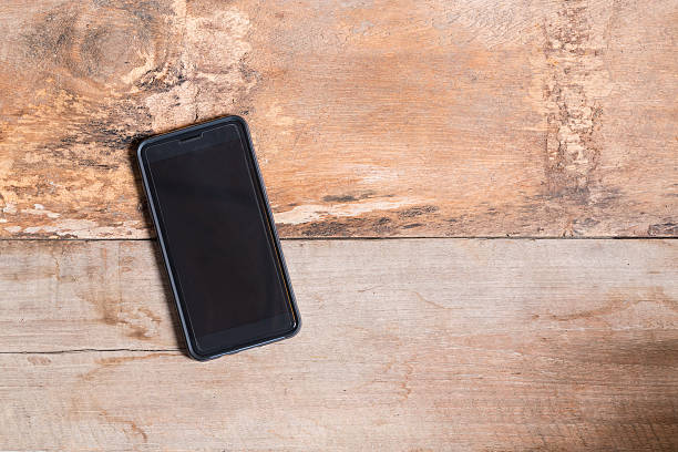 istock Smart phone on wooden table background with copy space 601104980