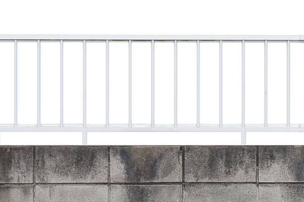 istock White metal fence and concrete block wall isolated 601105534