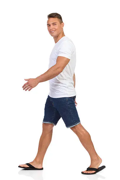 Photo of Smiling Young Casual Man Walking