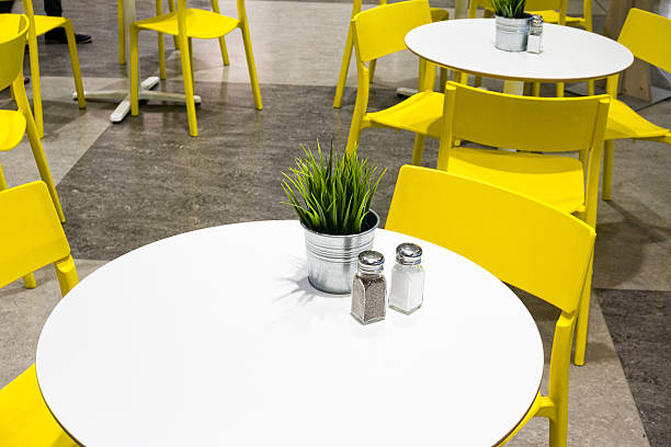 Colorful Yellow Chairs and Table Cafe - Table with wheat grass decoration and salt and pepper shakers.
