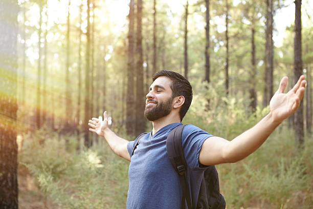 istock Happy young man feeling the forest 601115442