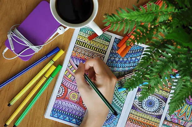 Colouring an anti-stress colouring book for adults