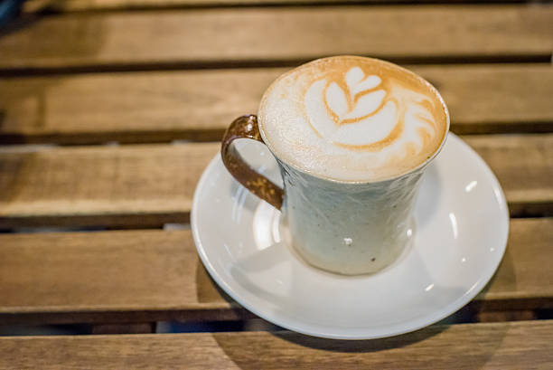 istock Cup of coffee latte art on wood table 601117918