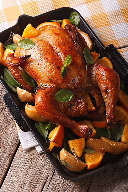 istock roast chicken with oranges and apples close-up in a pan 601118908