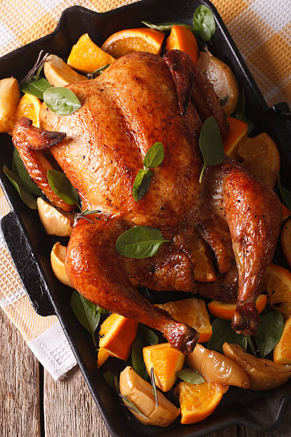 istock chicken roasted with oranges close-up in pan. vertical top view 601119576