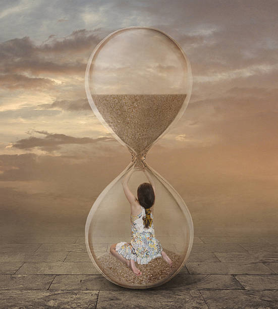istock There is a girl into a hourglass. 601124788