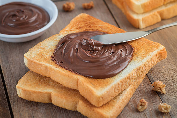 istock Bread with chocolate cream on wooden table 601126102