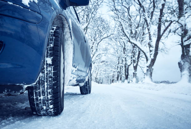 istock Car tires on winter road 601126516