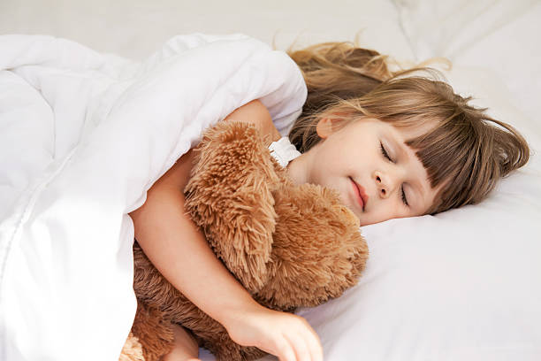 istock Little girl sleep in bed 601126906